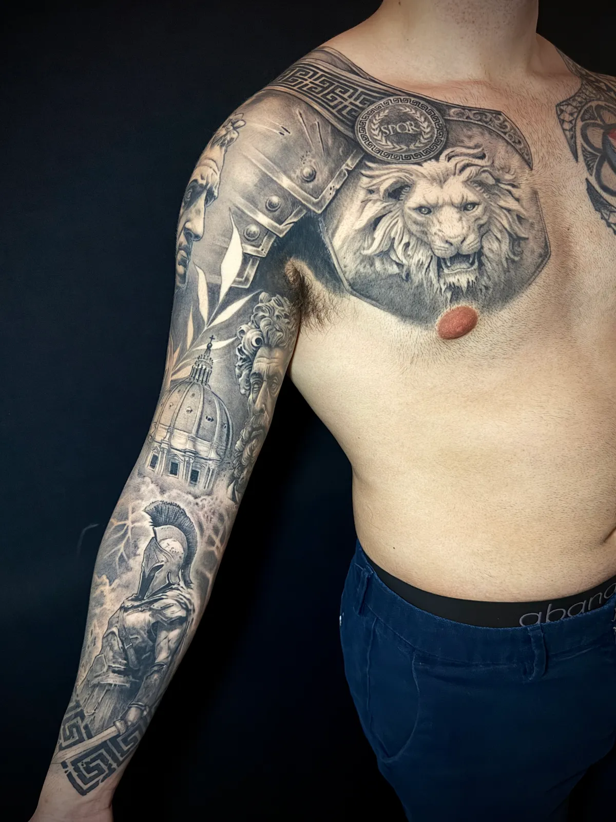 Black and grey realism Roman armor full sleeve and chest piece tattoo by Paul Michael Andras