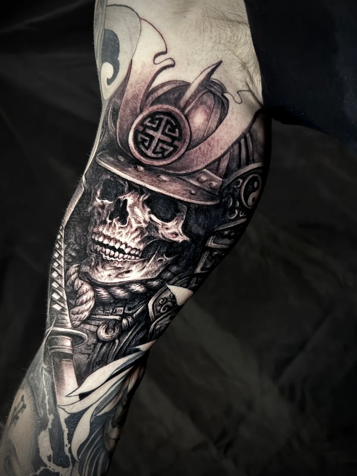 Black and grey realism Japanese samurai skull with helmet and sword forearm sleeve by Paul Michael Andras